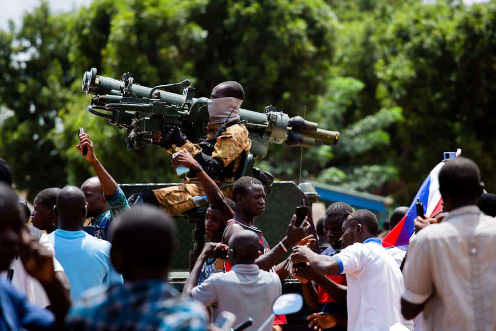 Soldiers loyal to Captain Ibrahim Traore are cheered in the streets of Ouagadougou in Burkina Faso on Sunday (Kilaye Bationo/AP)