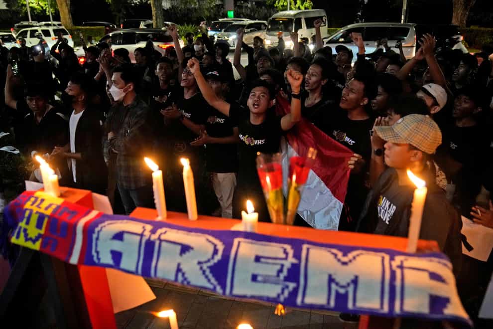 Football fans at a candlelit vigil in Jakarta, Indonesia, for Arema FC Supporters who became victims of Saturday’s tragedy (Dita Alangkara/AP)
