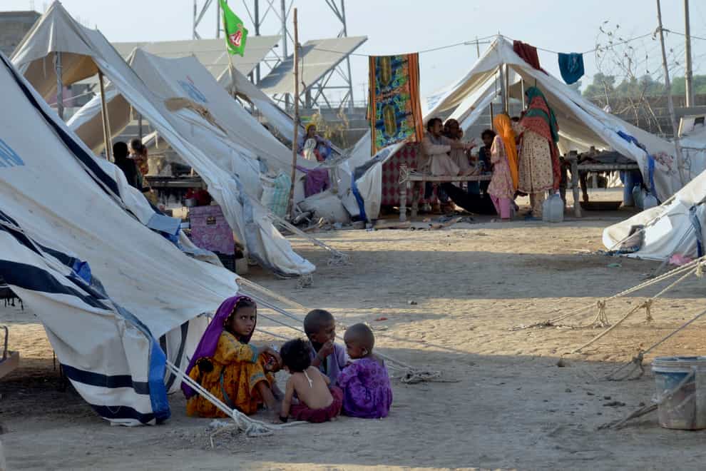 Children play outside their tent at a relief camp, in Jaffarabad, a district in the south-western Baluchistan province (AP)