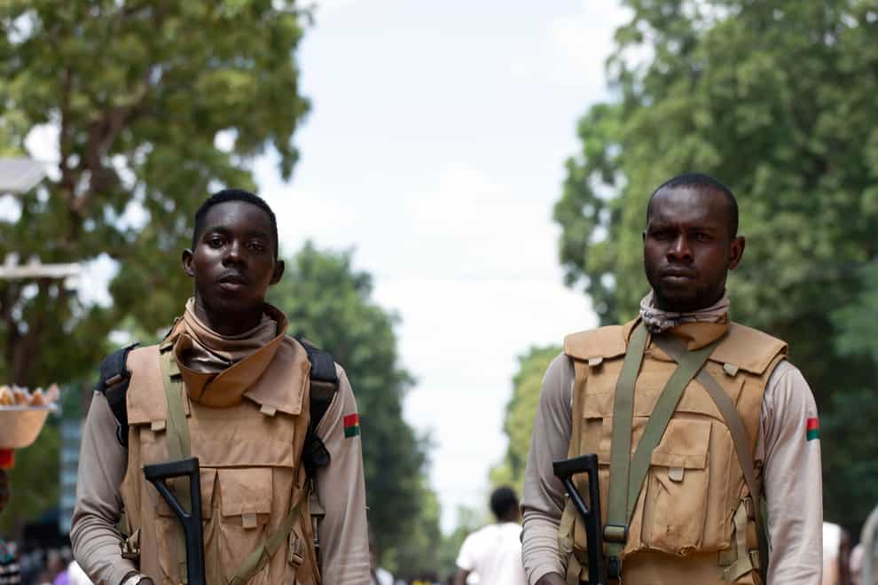 Soldiers loyal to Capt Ibrahim Traore walk in the streets of Ouagadougou (AP)