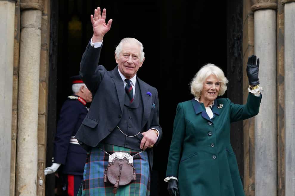King Charles III and the Queen Consort wave as they leave Dunfermline Abbey after a visit to mark its 950th anniversary, and after attending a meeting at the City Chambers in Dunfermline, Fife, where the King formally marked the conferral of city status on the former town (Andrew Milligan/PA)