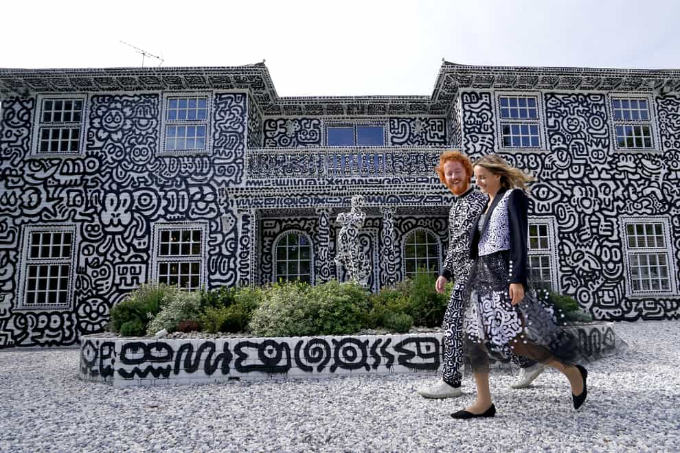 British artist Sam Cox, aka Mr Doodle, with his wife Alena, reveals the Doodle House, a 12-room mansion at Tenterden, in Kent (Gareth Fuller/PA)