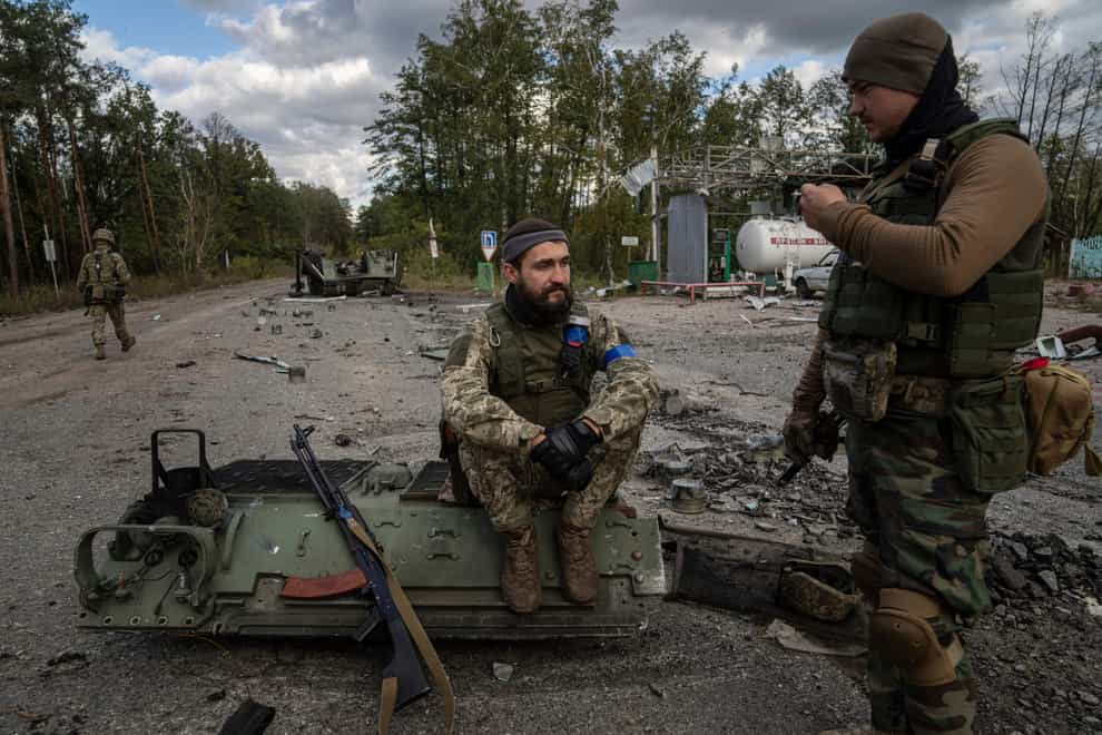 Ukrainian servicemen in the recently recaptured town of Lyman (Evgeniy Maloletka/AP)