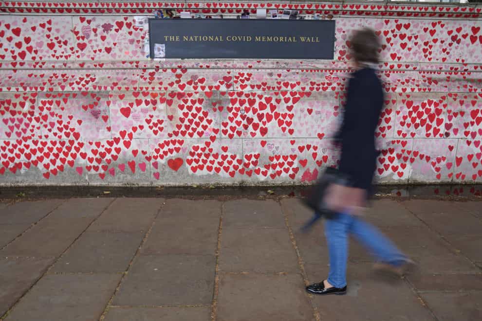 A person walks past the Covid memorial wall in central London (Jonathan Brady/PA)