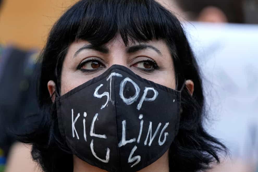 An activist in Lebanon wears a message on her protective face mask during a protest against the death of Mahsa Amini (AP)
