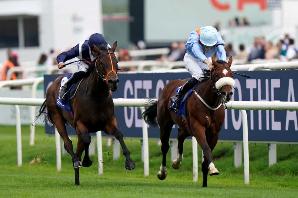 Trillium ridden by Pat Dobbs (left) passes The Platinum Queen ridden by Oisin Orr to win the Coral Flying Childers Stakes at Doncaster Racecourse. Picture date: Sunday September 11, 2022.