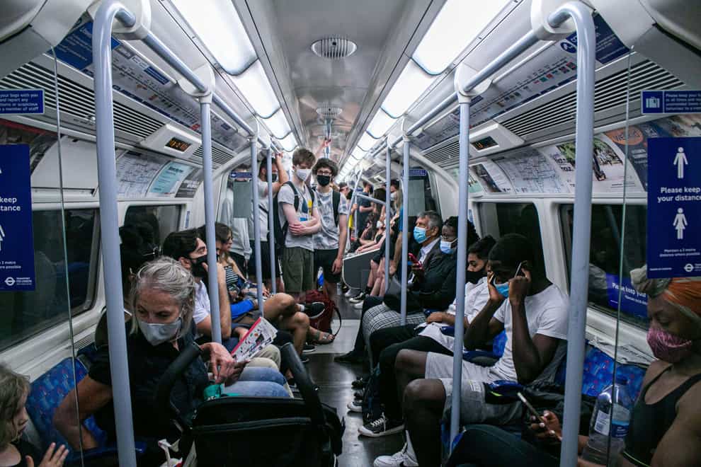 Passengers on a busy underground train in July 2021. Wearing facemasks remained mandatory for people travelling on the London Underground despite the lifting of lockdown restrictions. (Amer Ghazzal/Alamy/PA)