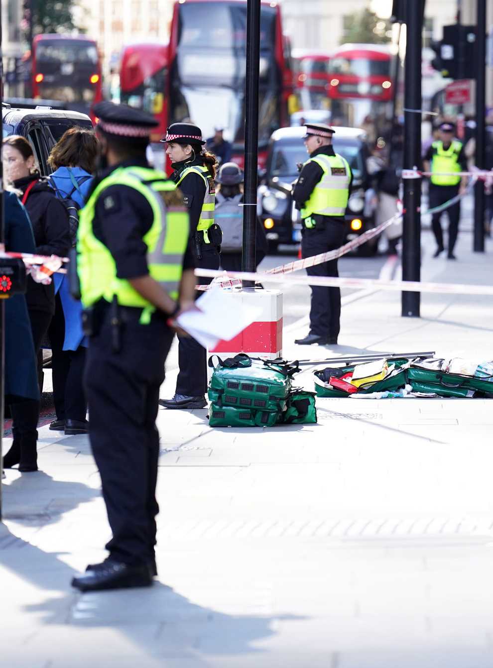 Police officers at the scene after three people were taken to hospital following reports of stabbings at Bishopsgate in London (James Manning/PA)