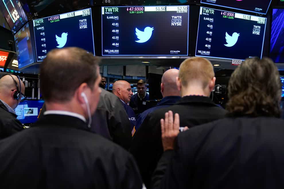 Traders gather around a post as Twitter shares resume trading on the floor at the New York Stock Exchange in New York, Tuesday, Oct. 4, 2022 (Seth Wenig/AP/PA)