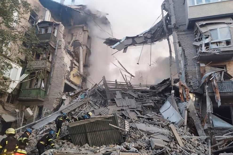 Rescuers work at a building damaged by shelling in Zaporizhzhia (Ukrainian Emergency Service via AP Photo)