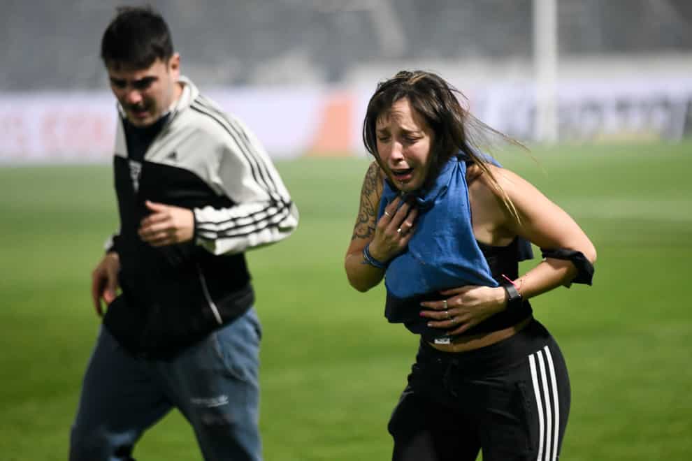 Fans of Gimnasia choked on tear gas during a match against Boca Juniors in La Plata (Gustavo Garello/AP)