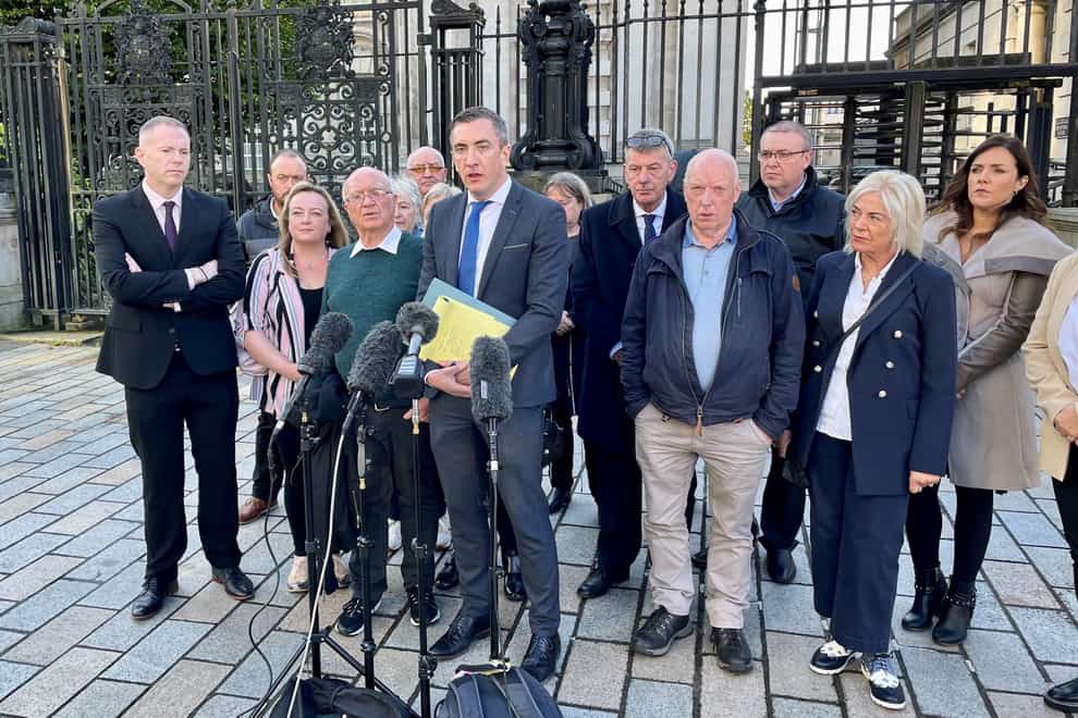 Peter McEvoy and supporters speak outside the High Court in Belfast following a legal challenge to police over its duty to ensure an effective investigation into a 1992 loyalist gun attack in Co Down (David Young/PA)