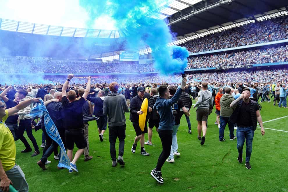 Manchester City fans invaded the pitch after the Premier League title was clinched with victory over Aston Villa (Martin Rickett/PA)