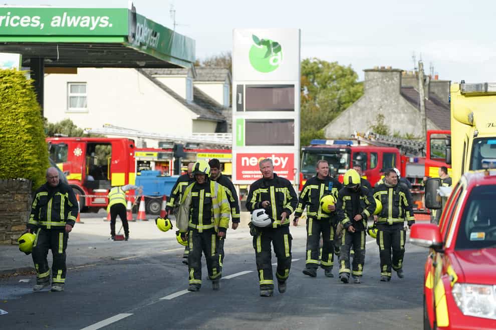 Firefighters leave the scene of the explosion (Brian Lawless/PA)