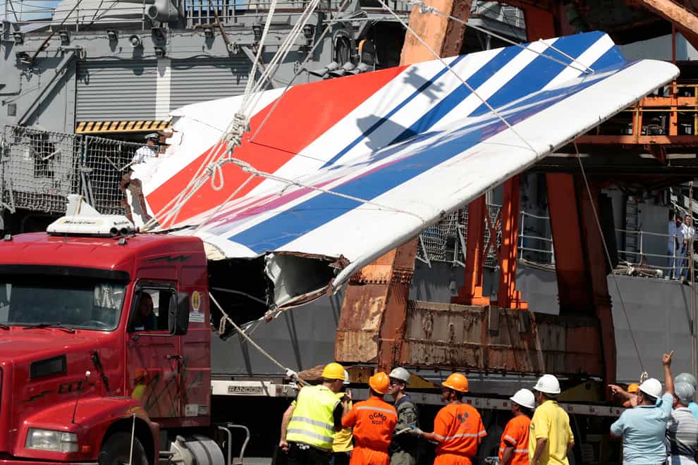 Workers unload debris belonging to the crashed Air France flight AF447 from the Brazilian navy’s Constitution Frigate in the port of Recife, north-east of Brazil on June 14 2009 (Eraldo Peres/AP)