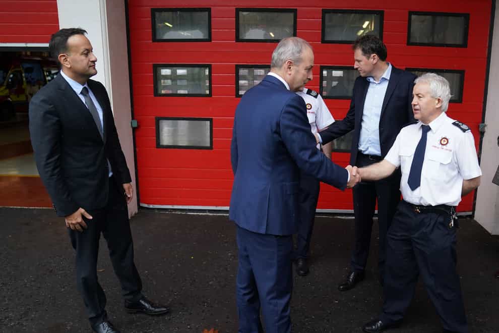Tanaiste Leo Varadkar (left) and Taoiseach Micheal Martin (centre) meeting chief fire officer Joseph McTaggart (right) at Letterkenny fire station (Brian Lawless/PA)