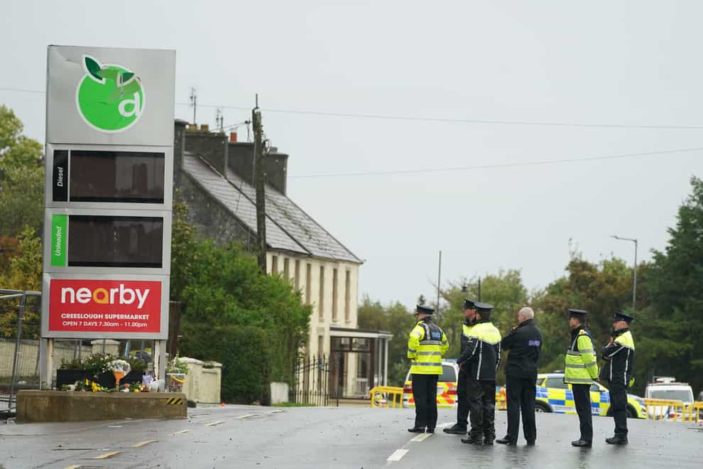 Garda Commissioner Drew Harris, left, at the scene of the explosion at Applegreen service station in the village of Creeslough, Co Donegal (PA)