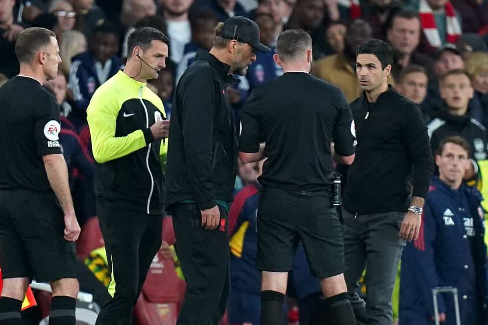 Referee Michael Oliver, centre, spoke to Liverpool manager Jurgen Klopp and Arsenal boss Mikel Arteta during the closing stages (Adam Davy/PA)
