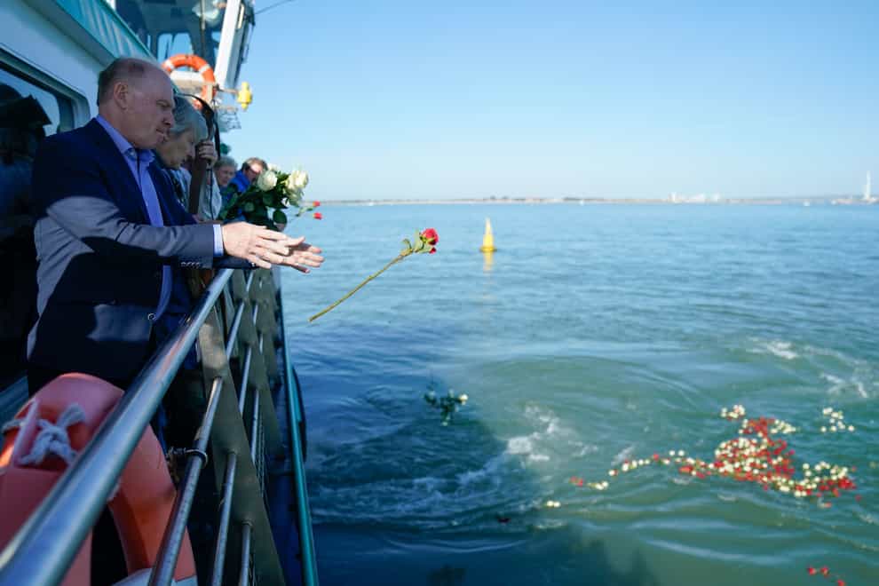 Mary Rose Trust chairman Nigel Purse joins others to cast 500 roses into the sea (Andrew Matthews/PA)