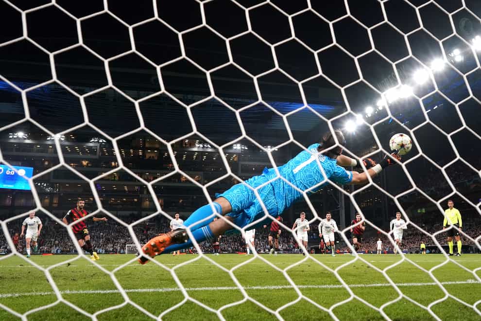 FC Copenhagen goalkeeper Kamil Grabara makes a save from the penalty kick of Manchester City’s Riyad Mahrez (second left) during the UEFA Champions League Group G match at Parken Stadium, Copenhagen. Picture date: Tuesday October 11, 2022.