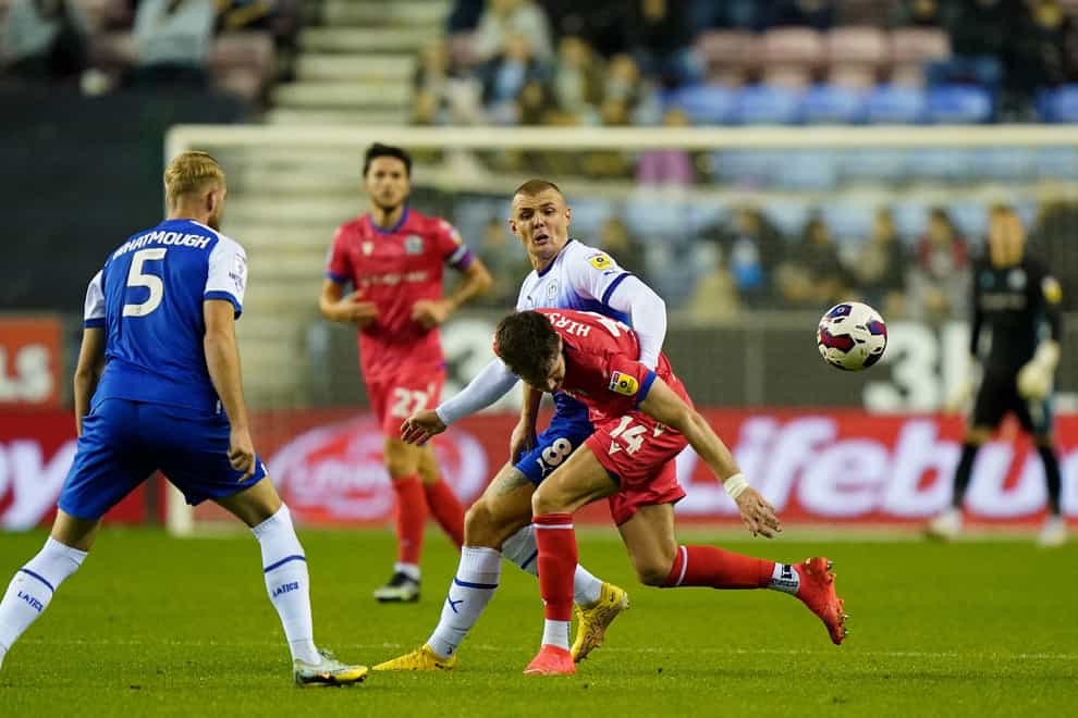 Blackburn Rovers’ George Hirst (right) and Wigan Athletic’s Max Power battle for the ball during the Sky Bet Championship match at the DW Stadium, Wigan. Picture date: Tuesday October 11, 2022.