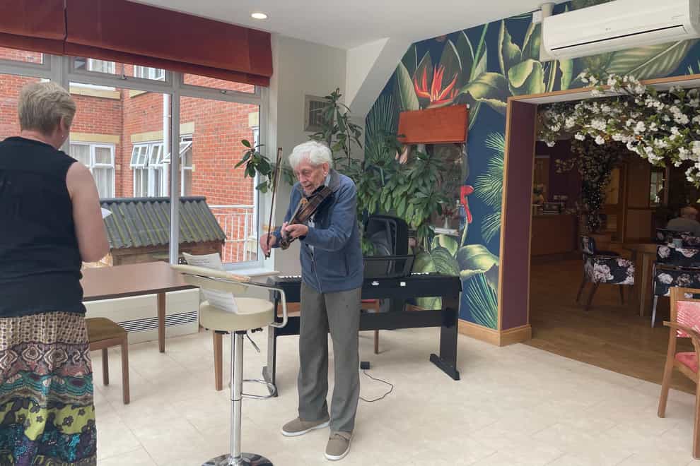 David Brown playing the violin (Foxholes Care Home/PA)
