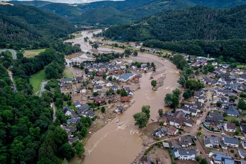 The Ahr river floats past destroyed houses in Insul, Germany, last July (AP)