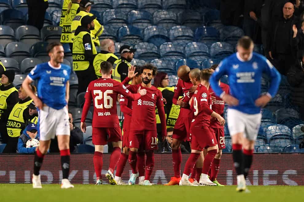 Liverpool celebrate one of their seven goals at Ibrox (Andrew Milligan/PA)