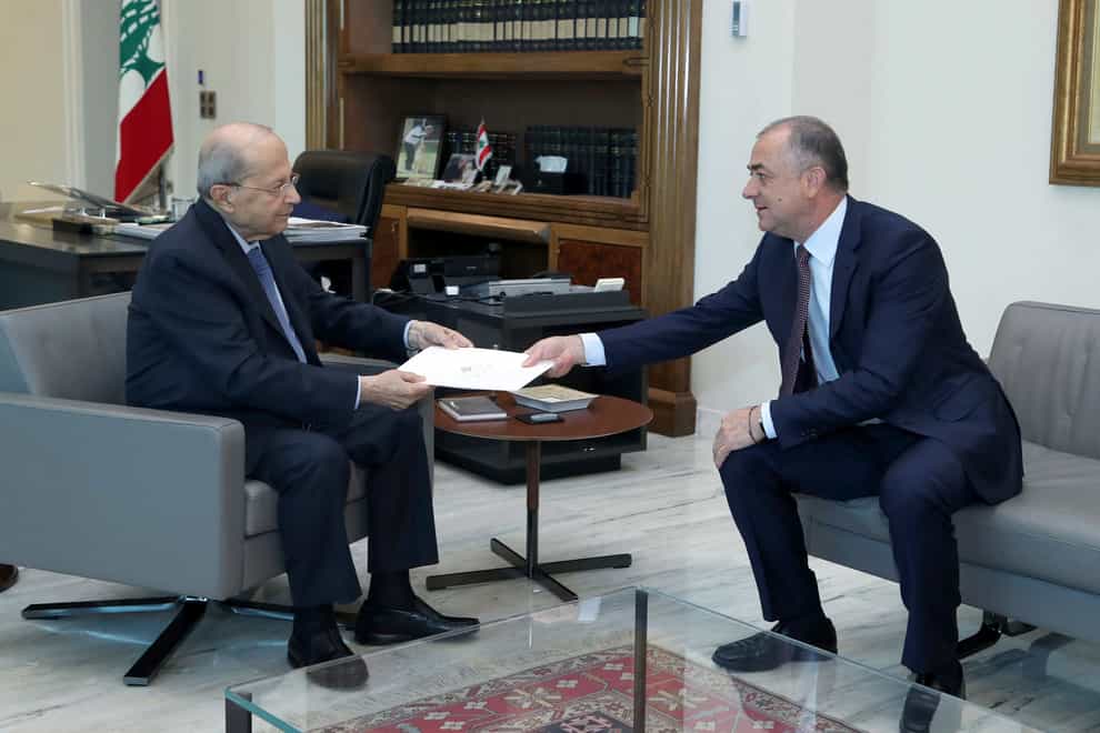 Lebanese President Michel Aoun, left, receives the final draft of the deal (Dalati Nohra via AP)