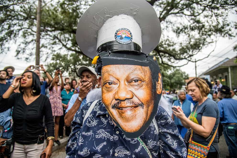 FILE – Fans parade down Poland Avenue toward the former home of music legend Antoine ‘Fats’ Domino (Invision/AP)