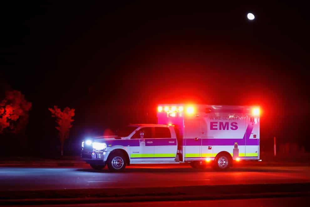 An ambulance rushes down New Bern Avenue after five people were shot and killed in the Hedingham Neighbourhood and Nuese River Trail area in Raleigh (The News & Observer via AP)