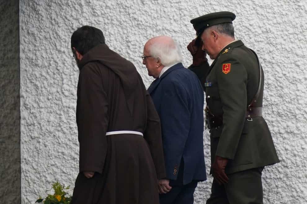President Michael D Higgins (centre) arrives at St Michael’s Church in Creeslough for the funeral Mass of Robert Garwe and his five-year-old daughter Shauna Flanagan Garwe (Niall Carson/PA)