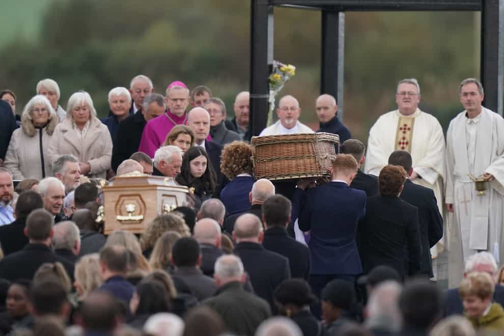 The coffins of Robert Garwe and his five-year-old daughter Shauna Flanagan Garwe are carried into church (Niall Carson/PA)