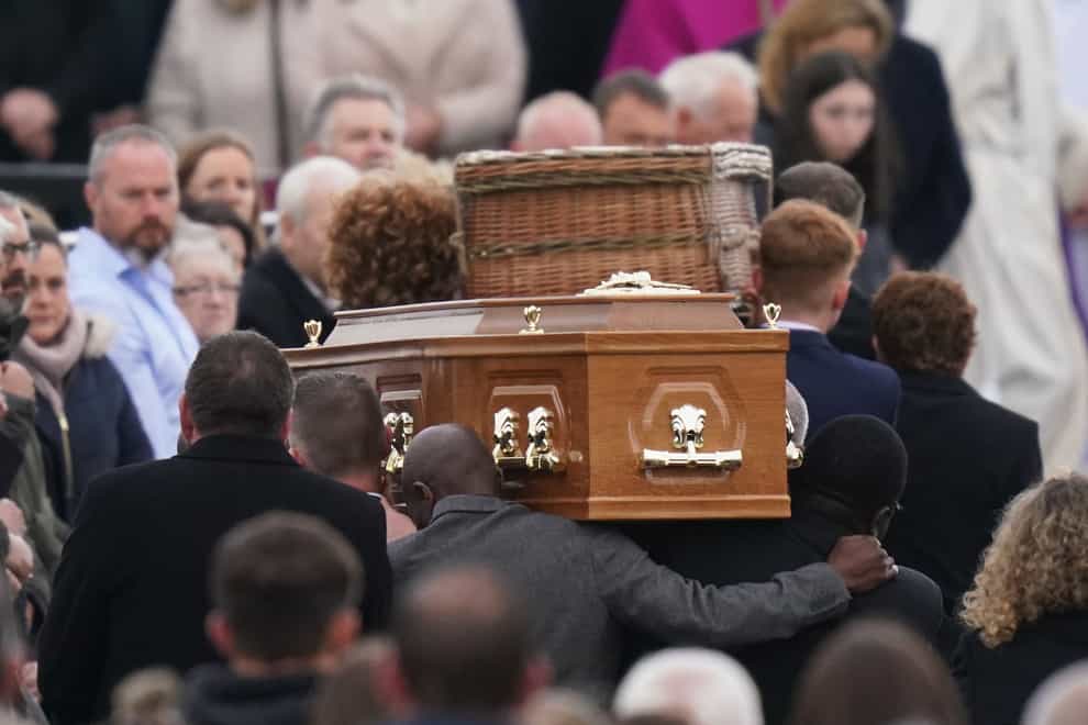 The coffins of Robert Garwe and his five-year-old daughter Shauna Flanagan-Garwe, who died following an explosion at the Applegreen service station in the village of Creeslough in Co Donegal, are carried into St Michael’s Church, in Creeslough, for their funeral Mass (Niall Carson/PA)