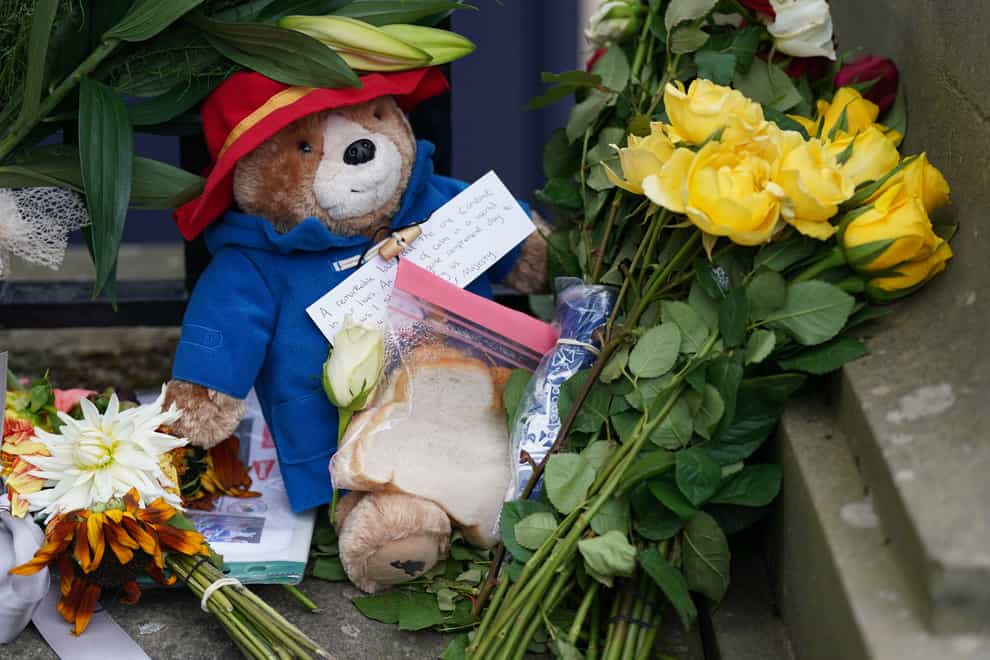A toy Paddington Bear and a marmalade sandwich left for the Queen (PA)