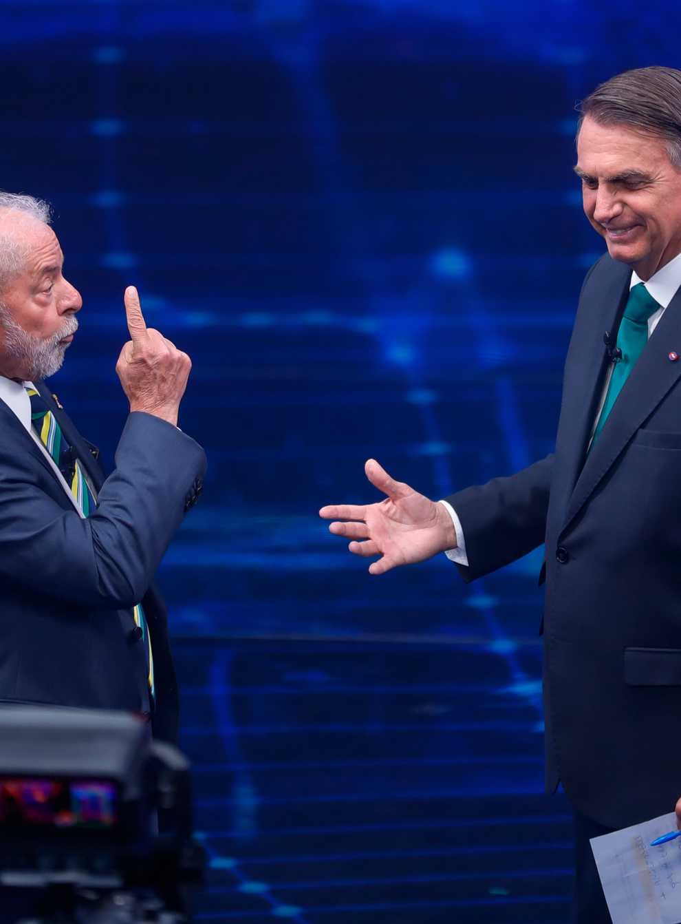 Brazil’s former President Luiz Inacio Lula da Silva, who is running for office again, left, faces Jair Bolsonaro in a presidential debate (AP)