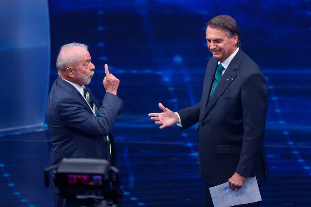 Brazil’s former President Luiz Inacio Lula da Silva, who is running for office again, left, faces Jair Bolsonaro in a presidential debate (AP)