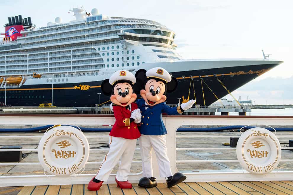 Captain Minnie and Mickey in front of the Disney Wish at Port Canaveral, Florida (Disney Cruise Line/David Roark/PA)