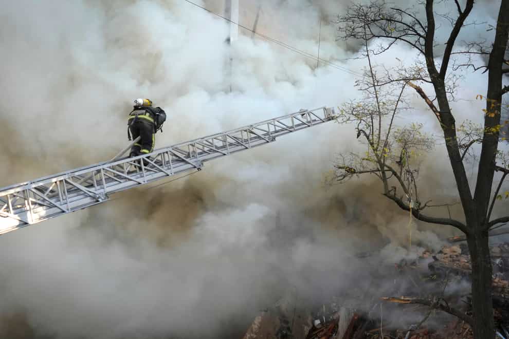Firefighters work after a drone fired on buildings in Kyiv, Ukraine (AP)