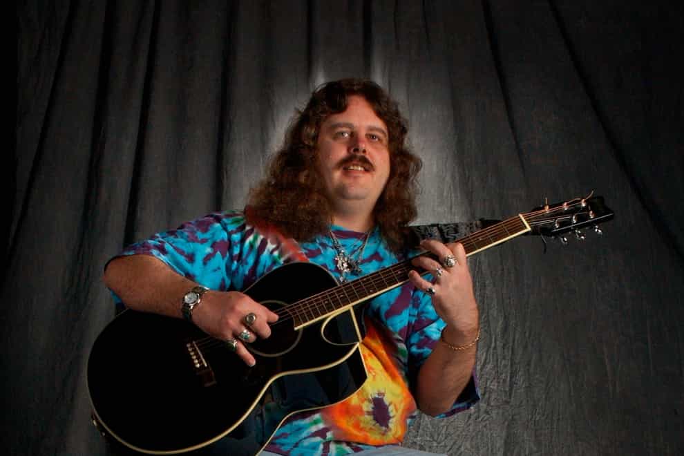 Mike Schank poses with a guitar in 2002 (Gary Porter/Milwaukee Journal-Sentinel/AP)