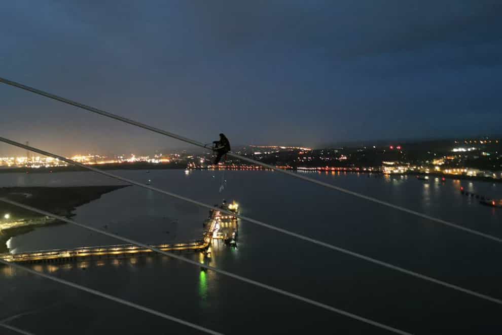 A Just Stop Oil activist scaling the Queen Elizabeth II Bridge at the Dartford Crossing on Monday (Just Stop Oil/PA)