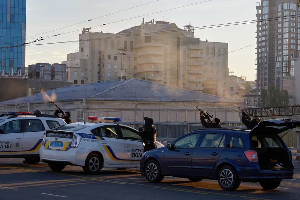 Ukrainian soldiers shoot a drone that appears in the sky seconds before it fired on buildings in Kyiv (Vadym Sarakhan/AP)