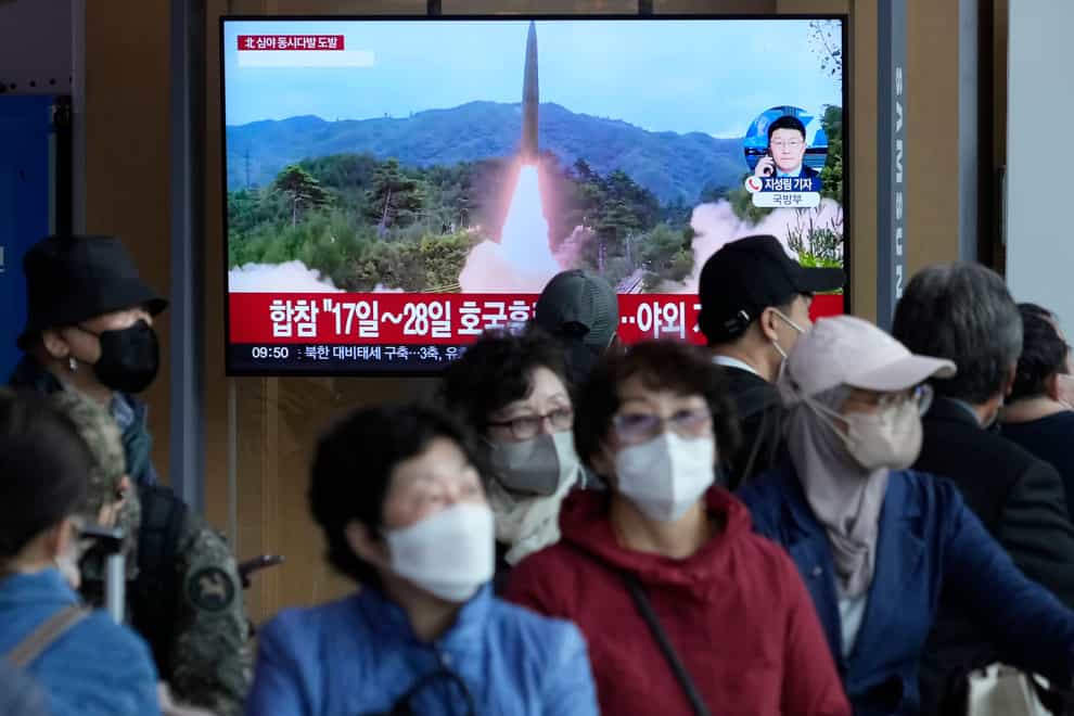 A TV screen shows a file image of North Korea’s missile launch during a news programme at the Seoul Railway Station in South Korea on October 14 2022 (Ahn Young-joon/AP)