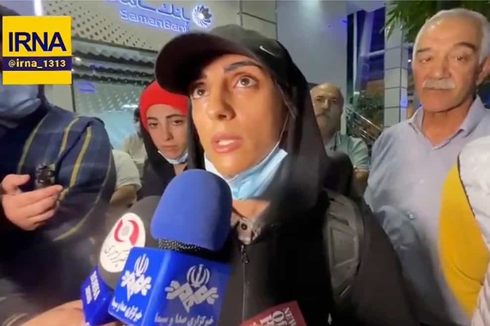 Iranian competitive climber Elnaz Rekabi speaks to journalists in Imam Khomeini International Airport in Tehran (IRNA via AP)
