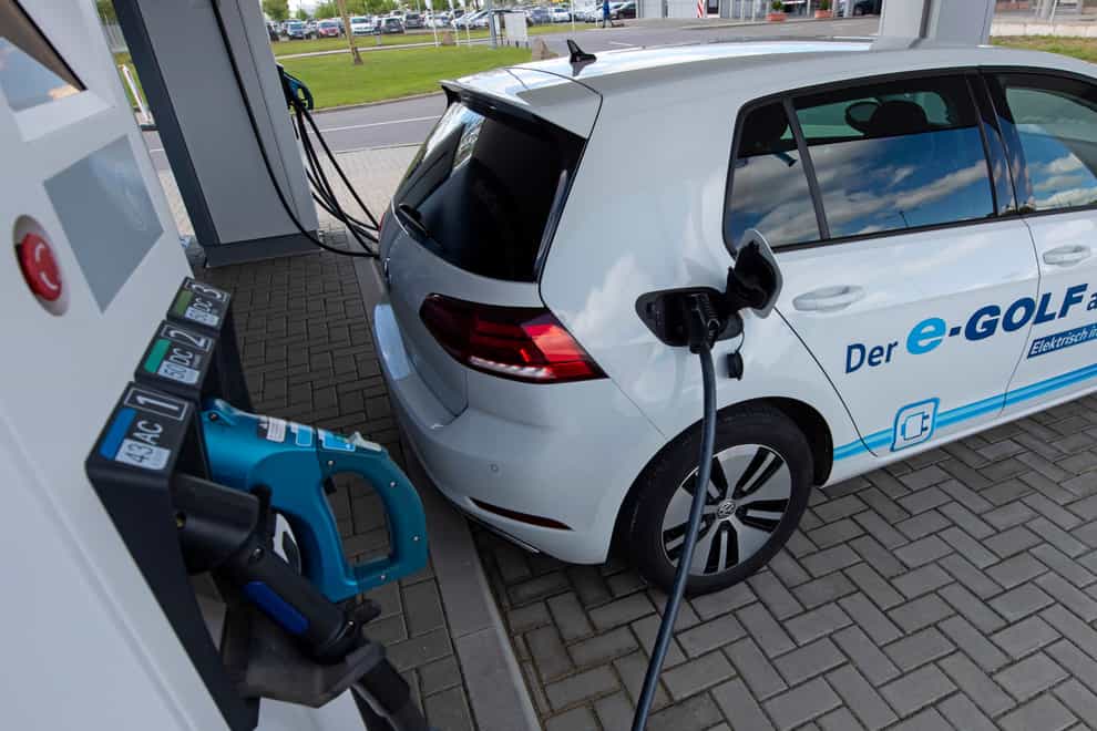 An electric car is charged at a charging station during a press tour of the plant of the German manufacturer Volkswagen AG in Zwickau, Germany (AP)