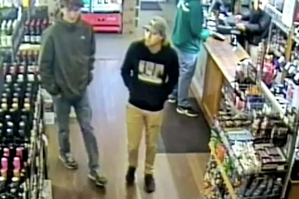CCTV still of missing Belgian backpacker Theo Hayez, centre, wearing black hooded jumper, inside a liquor store in Byron Bay on the day he disappeared in 2019 (New South Wales Police Force via AP, File)