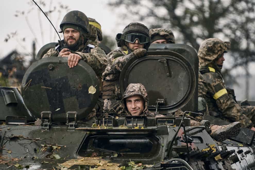 Ukrainian soldiers ride an APC in Donetsk region (AP)