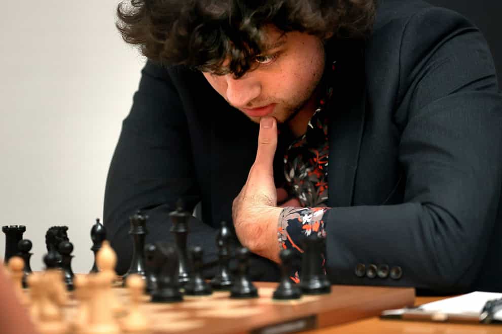 Chess Grandmaster Hans Niemann, 19, studies the board (David Carson/St. Louis Post-Dispatch via AP)