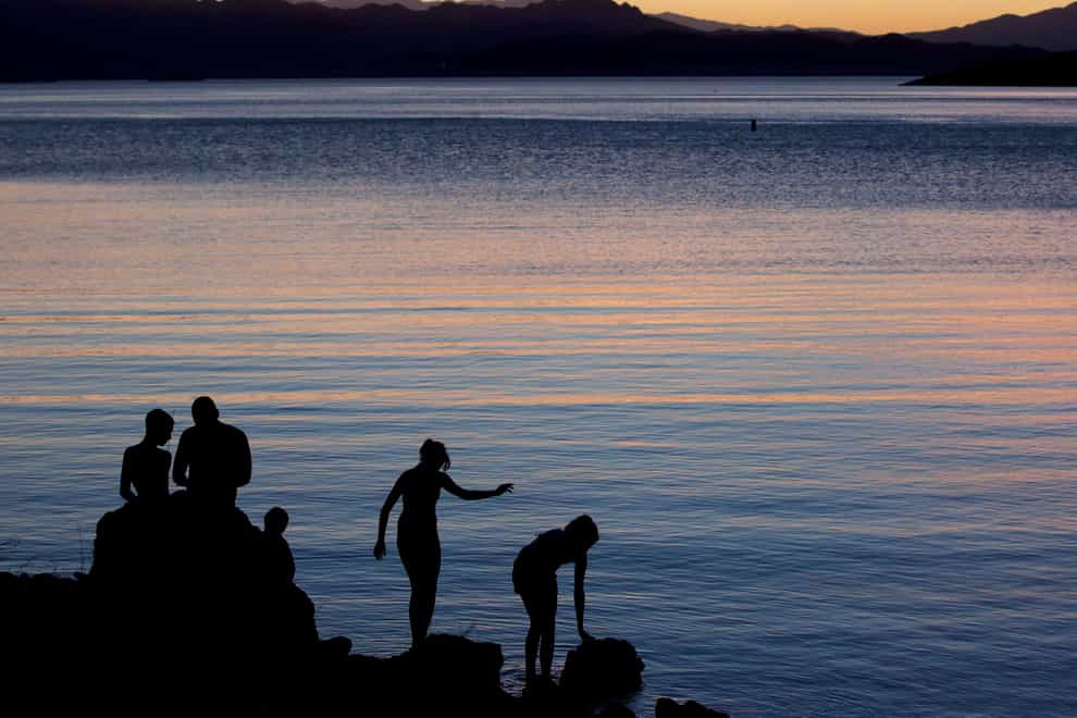 People at the edge of Kingman Wash, at Lake Mead National Recreation Area in Arizona (Julie Jacobson/AP)