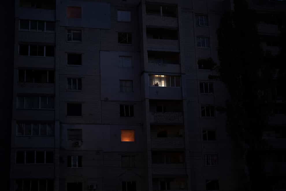 A man looks out from a window in a building damaged by fighting between Ukrainian and Russian forces in Borodyanka, Kyiv region, Ukraine (Emilio Morenatti/AP)